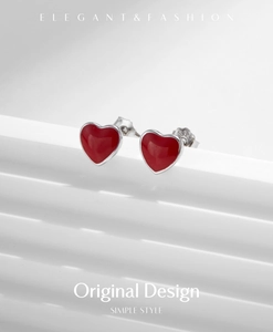 Macro shot of S925 sterling silver stamp on red heart-shaped stud earrings