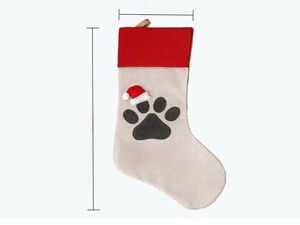 Detailed view of beige Christmas stocking with red cuff, paw print and 20x47cm dimensions