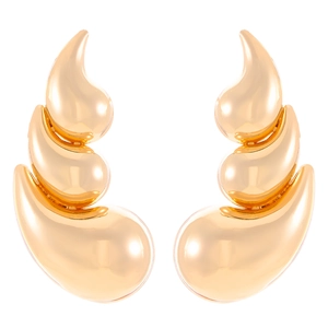 Detail of gold polished comma-shaped teardrop earrings with a sleek metallic finish