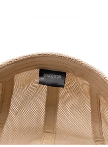 Detailed care label showing 80% cotton and 20% polyester blend of the mesh beret hat