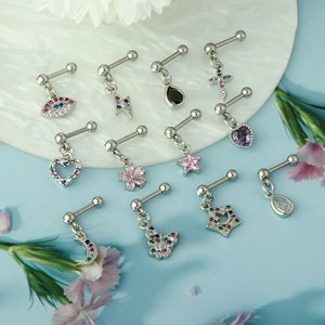Detailed display of silver stainless steel cartilage studs with various zircon pendants