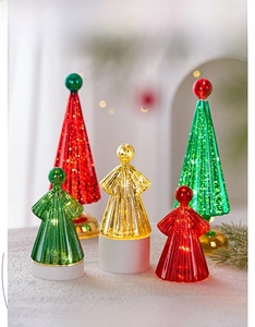 Close-up of LED glowing glass Christmas tree and angel night lights with warm festive lighting