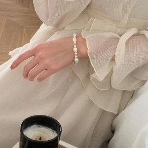 Close-up of natural freshwater pearl bracelet worn on wrist with elegant baroque pearls