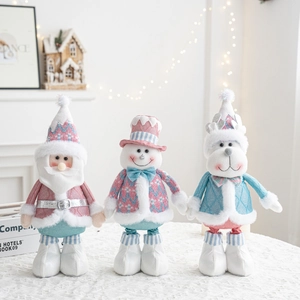 Close-up of pink and mint green Christmas plush dolls including Santa, Snowman and Reindeer
