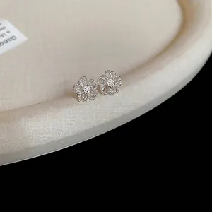 Elegant silver hollow floral stud earrings featuring intricate filigree petal designs