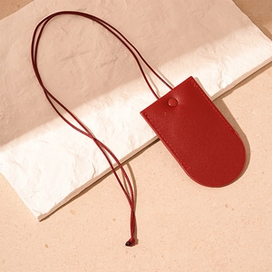 Detail of red pebbled leather key case with matching lanyard and fine stitching finish