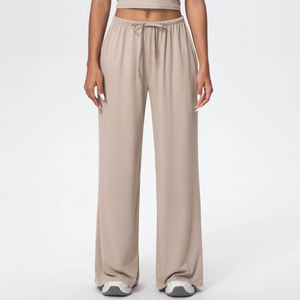Close-up of elastic drawstring waistband on beige wide-leg lounge pants for women