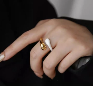 Minimalist gold plated water drop ring with white enamel finish worn on finger