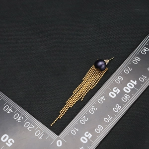 Natural pearl tassel earrings in 18k gold plating shown with ruler for size reference