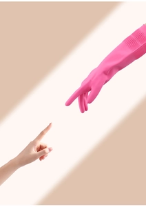 Close-up of pink latex cleaning glove with non-slip texture on palm and fingers