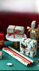 Detail of Christmas wrapping paper rolls with nutcracker motifs and festive ribbons