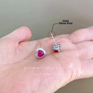Detailed view of S925 silver heart ruby earrings with sparkling zircon halo setting