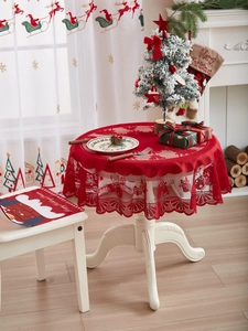 Detailed view of red Christmas lace tablecloth featuring reindeer and Santa embroidery