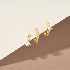 Detailed view of 3-piece gold vermeil earring set featuring turquoise and clear cubic zirconia