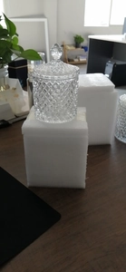 Detail of a large glass storage jar with diamond-cut texture and matching lid