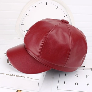 Detailed close-up of dark red PU leather baker boy hat showing premium grain texture
