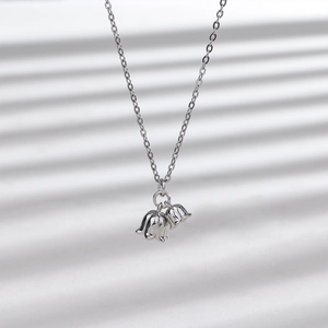 Detail macro shot of silver lily of the valley flower pendants on a delicate chain