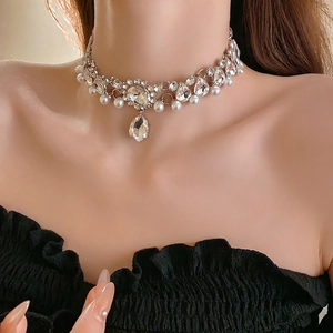Luxury floral necklace with water drop crystals and pearls on a model's neck