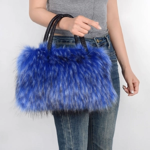 Close-up of blue faux fur tote bag with black handles held by model in casual outfit