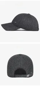 Detail of dark gray tweed baseball cap with metal logo and ear flap protection