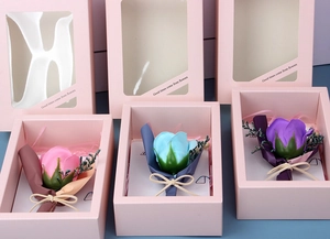Detailed view of gift boxes with colorful artificial soap roses and greeting cards