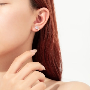 Close-up of 925 silver stud earring featuring a purple heart-shaped stone and zircon