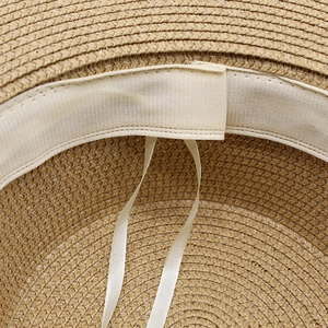 Detail of adjustable inner drawstring and sweatband on a woven straw sun hat