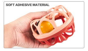 Close-up of hand squeezing flexible soft adhesive material of Manhattan ball toy