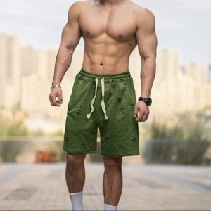 Close-up of olive green men's knit shorts featuring drawstring waist and distressed detail