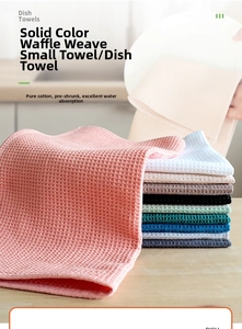 Close-up of pink 100% cotton waffle weave dish towel showing absorbent honeycomb texture