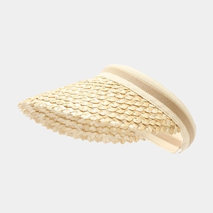 Detail of woven straw texture and elastic band on a stylish summer sun visor hat