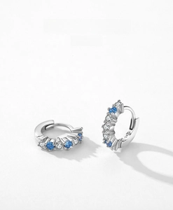 Close-up of S925 sterling silver earrings with alternating blue and white zircon stones