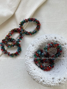 Detailed view of elastic hair tie featuring vibrant colorful crystals and stylish texture