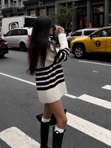 Street view of a woman in an oversized black and white striped sweater in NYC
