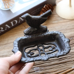 Vintage cast iron bird soap dish and tray with rustic shell pattern on wooden table