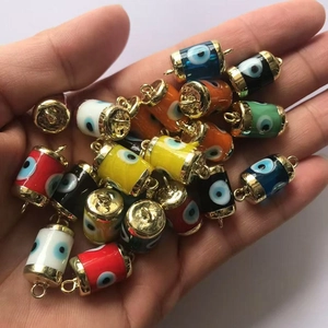 Close-up of colorful evil eye resin charms with gold caps for DIY jewelry making