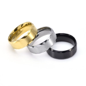 Macro view of 8mm faceted titanium steel rings in gold, silver and black finishes
