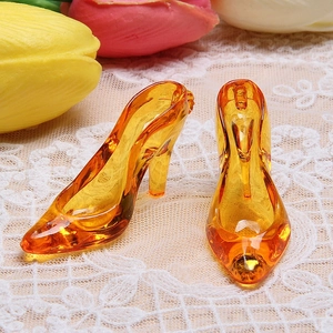 Detail of orange translucent high heel charms on lace fabric with tulip background