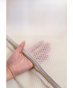 Detail of fine mesh laundry bag with smooth zipper for washing machine protection