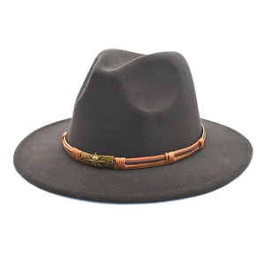 Detail of grey wool fedora hat featuring a brown leather strap and skull metal buckle