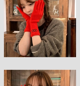 Detail showing red knitted gloves with black embroidered bow and soft textured cuffs