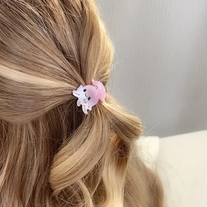 Close-up of pink octopus hair claw clip on blonde hair showing high quality details
