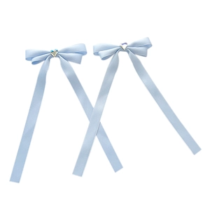 Light blue ribbon bow hair clips featuring a sparkling heart-shaped crystal center