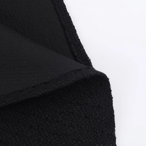 Macro detail showing the high-quality stitching and tweed texture of the black dress