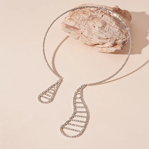 Close-up of silver-tone rhinestone choker featuring asymmetrical hollow teardrop charms