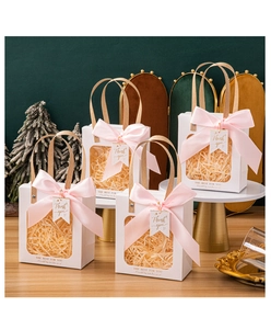 Detailed view of white gift bags with transparent windows, pink ribbons and thank you tags