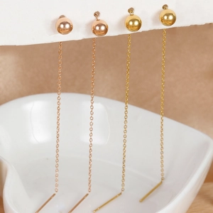Minimalist long chain tassel earrings with gold beads in rose gold and yellow gold