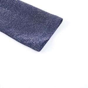 Macro detail of dark blue metallic knit fabric with silver glitter yarn and fine texture