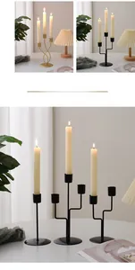 Detail of three-arm iron candle holder in gold and black for romantic table decor