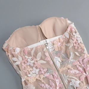 Detail of floral embroidery, sequins, and hidden zipper on the pink backless party dress
